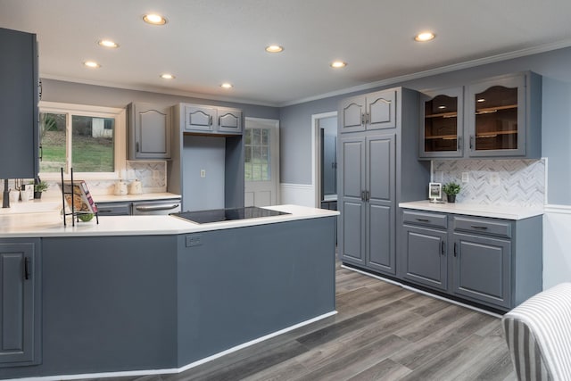 kitchen featuring dark wood-type flooring, crown molding, stainless steel dishwasher, gray cabinets, and black electric cooktop