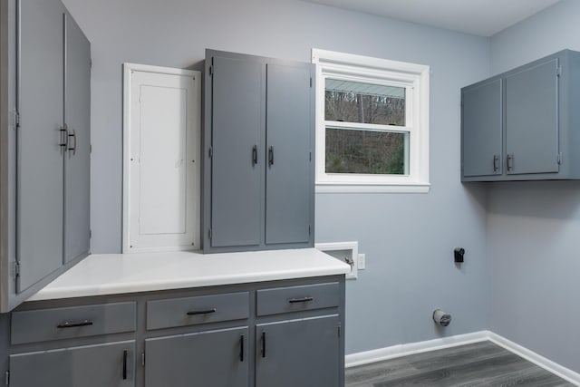 clothes washing area with cabinets, dark wood-type flooring, and hookup for a washing machine