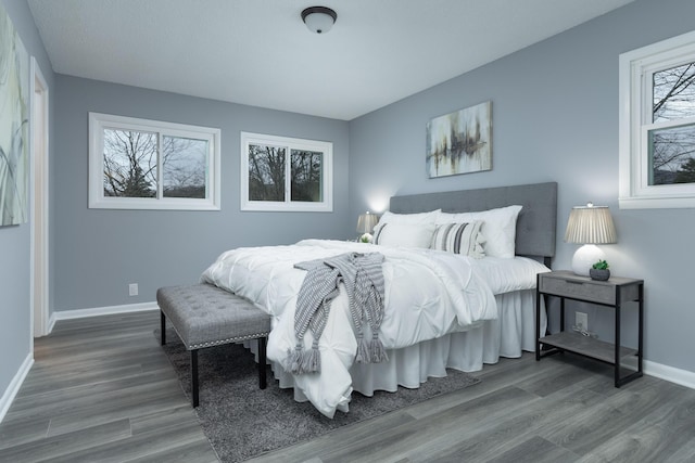 bedroom featuring hardwood / wood-style flooring and multiple windows