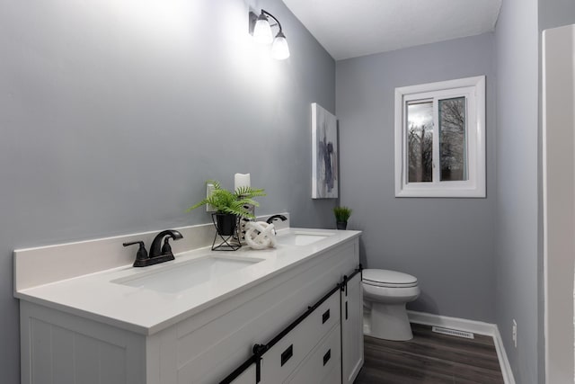 bathroom featuring hardwood / wood-style floors, vanity, and toilet