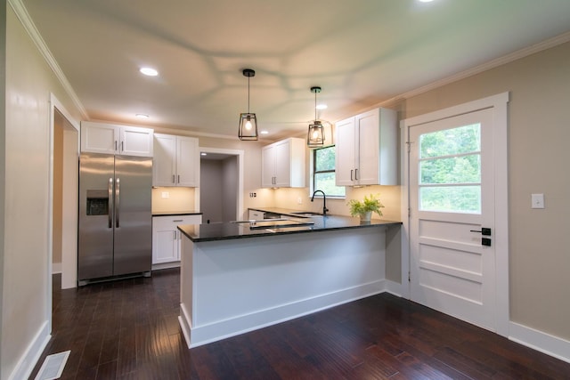 kitchen featuring white cabinets, stainless steel refrigerator with ice dispenser, kitchen peninsula, and sink