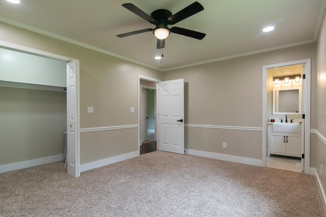 unfurnished bedroom featuring light carpet, sink, crown molding, ceiling fan, and connected bathroom