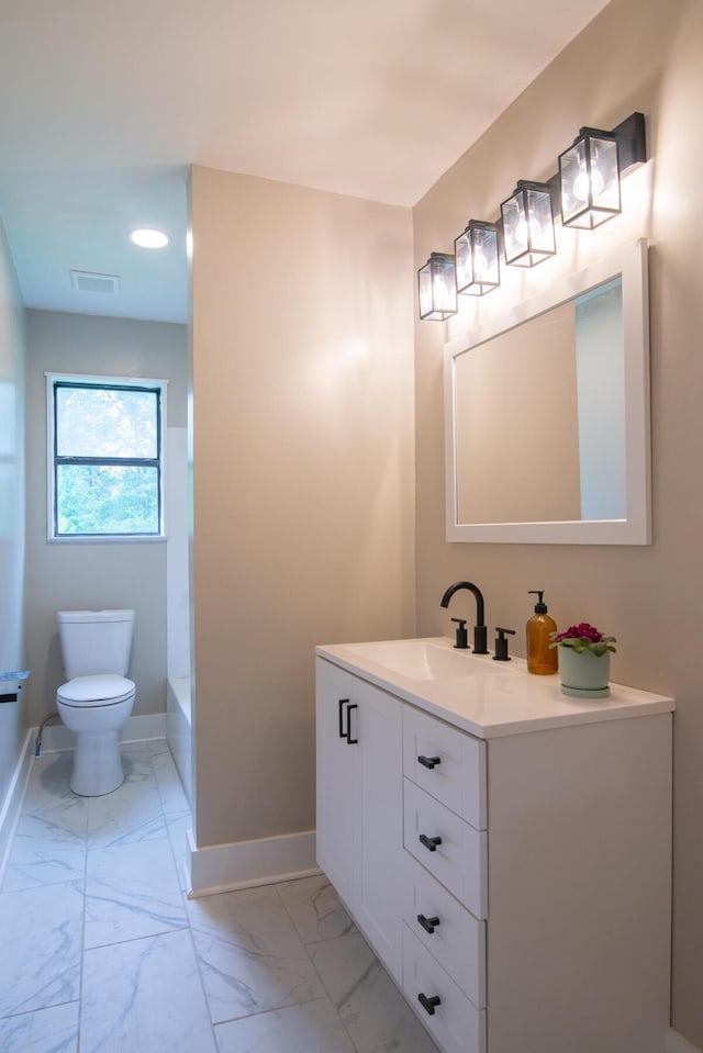 bathroom featuring vanity and toilet