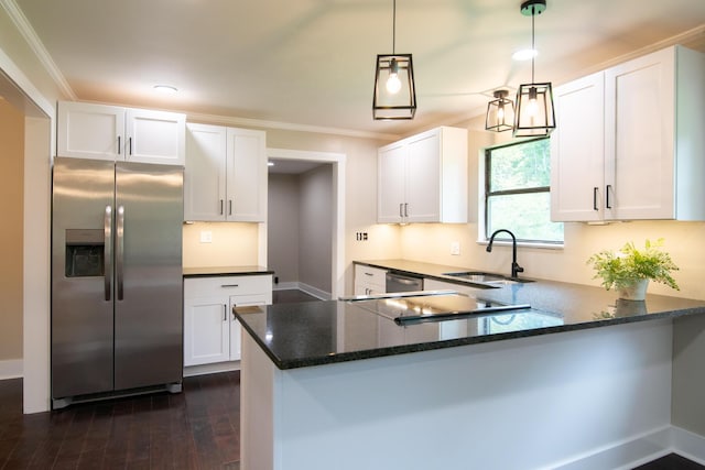 kitchen featuring sink, white cabinets, hanging light fixtures, and appliances with stainless steel finishes