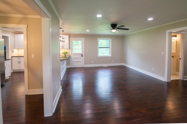 unfurnished living room featuring dark hardwood / wood-style floors, ceiling fan, and ornamental molding