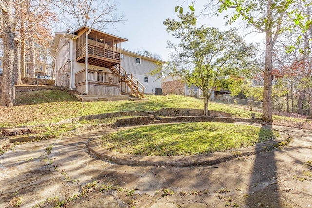 back of property with central AC, a sunroom, a yard, and a deck