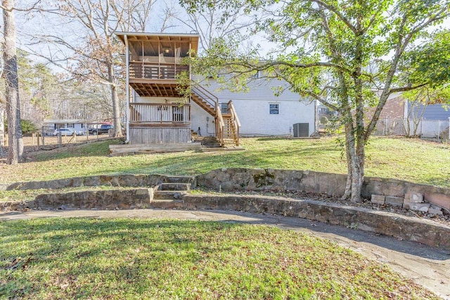 back of property featuring a yard, cooling unit, and a sunroom