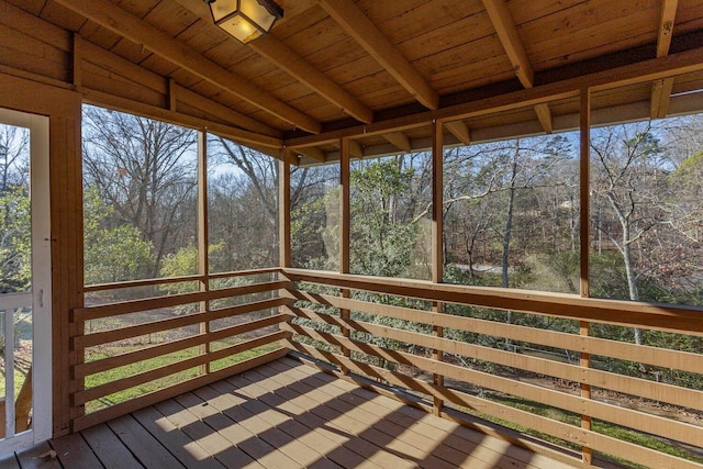 unfurnished sunroom with vaulted ceiling with beams and wooden ceiling