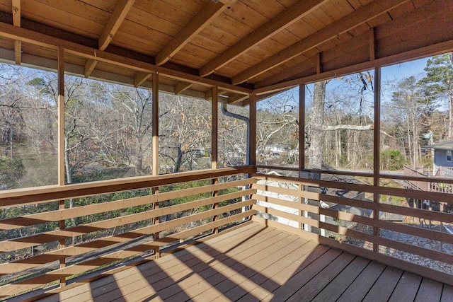 unfurnished sunroom with a healthy amount of sunlight and wooden ceiling