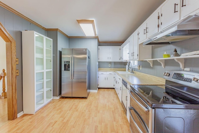 kitchen featuring decorative backsplash, appliances with stainless steel finishes, sink, light hardwood / wood-style flooring, and white cabinetry