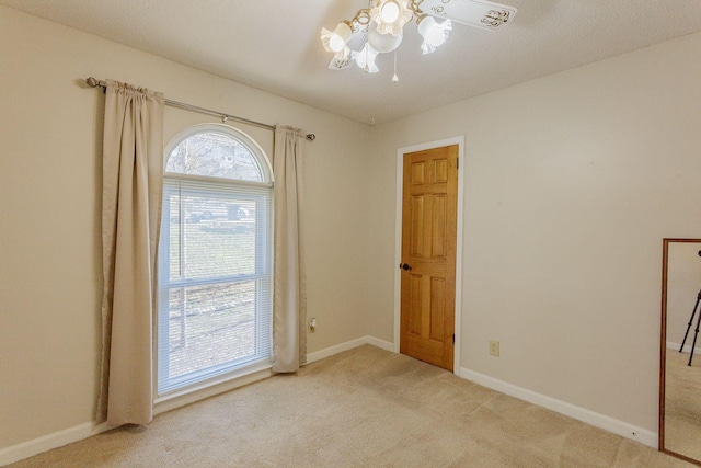 empty room featuring light carpet and ceiling fan