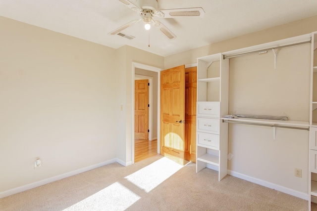 unfurnished bedroom with light carpet, a closet, and ceiling fan