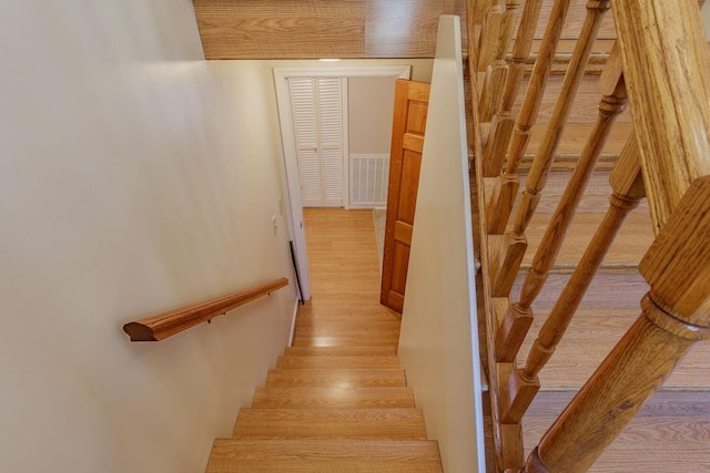 staircase featuring wood-type flooring