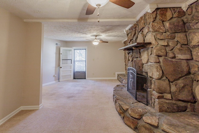 carpeted living room featuring a stone fireplace and a textured ceiling