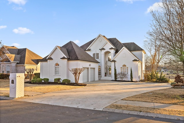 french country home featuring a garage