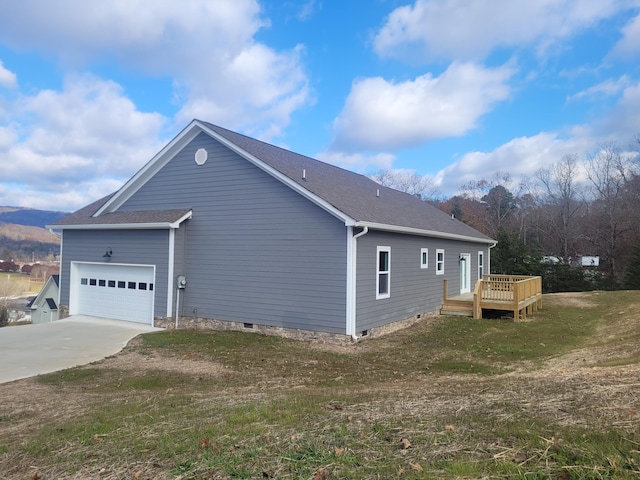 view of property exterior with a lawn, a garage, and a deck