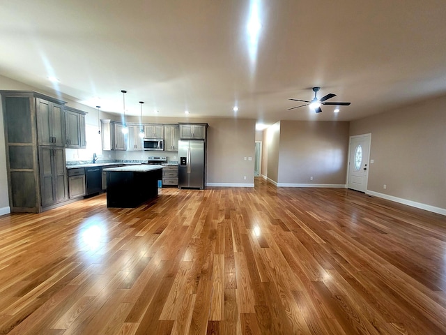 unfurnished living room featuring ceiling fan and wood-type flooring