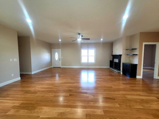 unfurnished living room featuring wood-type flooring and ceiling fan