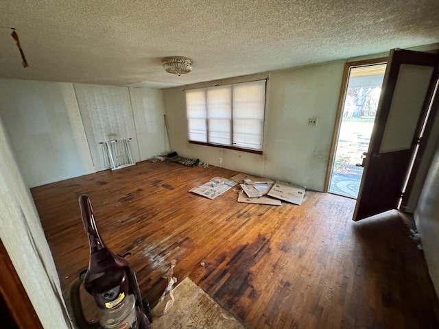 interior space featuring hardwood / wood-style flooring and a textured ceiling