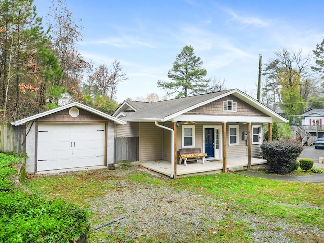 view of front of house with an outdoor structure, a front lawn, a porch, and a garage