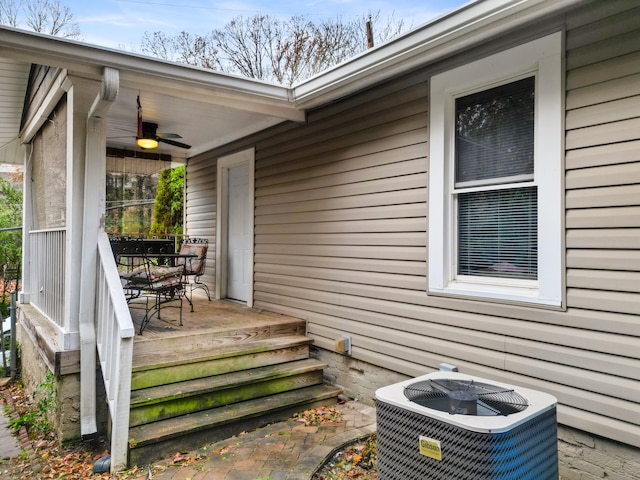 exterior space with central AC unit and ceiling fan