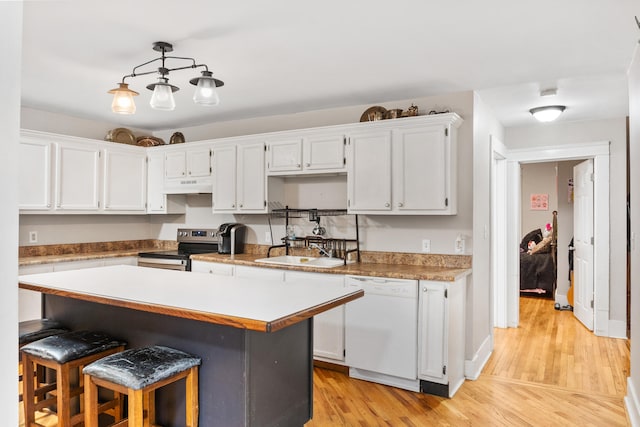 kitchen featuring a center island, white dishwasher, decorative light fixtures, stainless steel electric stove, and white cabinets