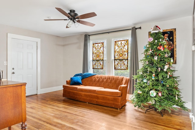 sitting room with ceiling fan and light hardwood / wood-style flooring