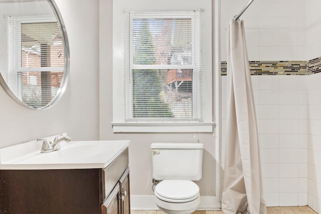 bathroom featuring a shower with curtain, toilet, and vanity