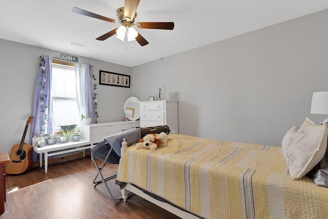 bedroom featuring ceiling fan and dark hardwood / wood-style floors