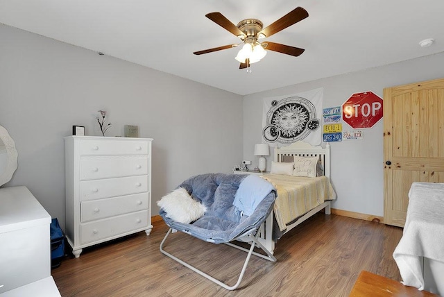 bedroom with ceiling fan and dark wood-type flooring