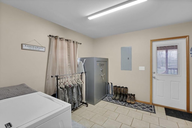 clothes washing area with washer and clothes dryer, light tile patterned floors, and electric panel