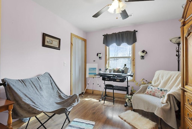 sitting room featuring ceiling fan and light wood-type flooring