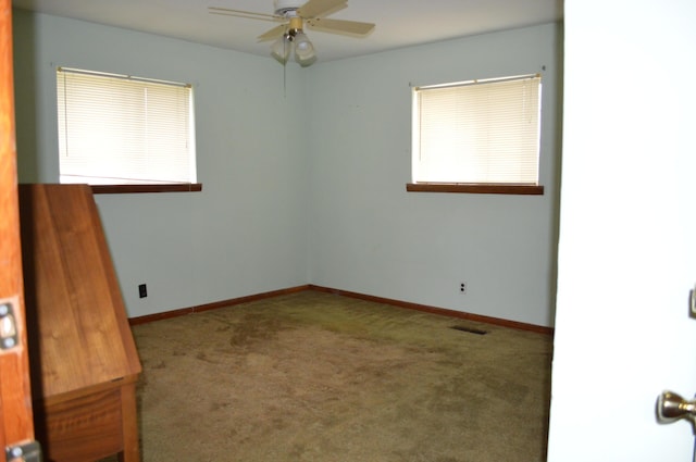 unfurnished room with ceiling fan and carpet