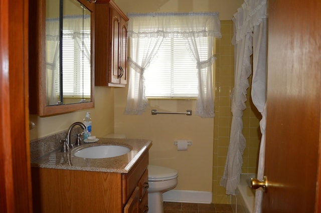 full bathroom with tile patterned flooring, vanity, toilet, and shower / bath combo with shower curtain