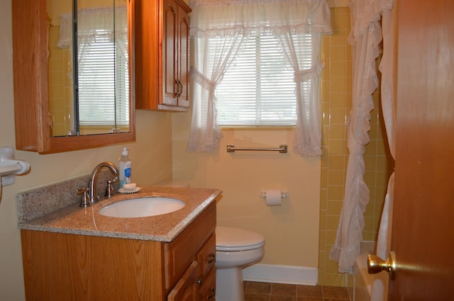 full bathroom featuring tile patterned flooring, vanity, toilet, and shower / tub combo with curtain