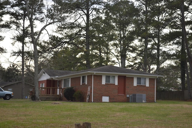 view of front facade with central air condition unit and a front lawn