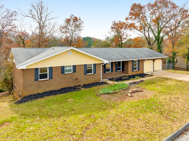 ranch-style house with a garage and a front lawn