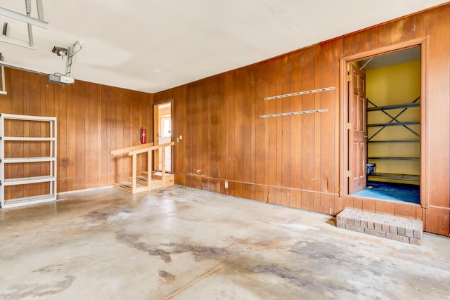 garage featuring wood walls