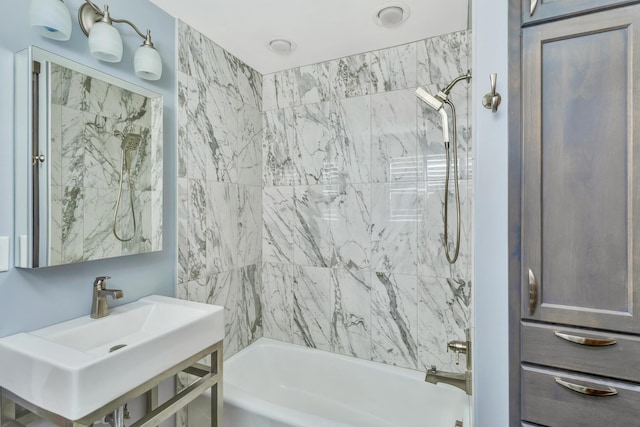 bathroom featuring sink and tiled shower / bath