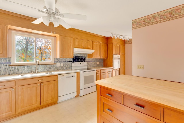 kitchen with backsplash, ceiling fan, sink, and white appliances