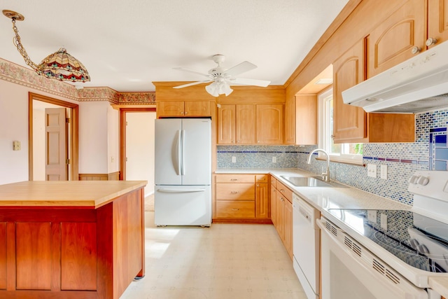 kitchen featuring tasteful backsplash, white appliances, ceiling fan, sink, and hanging light fixtures