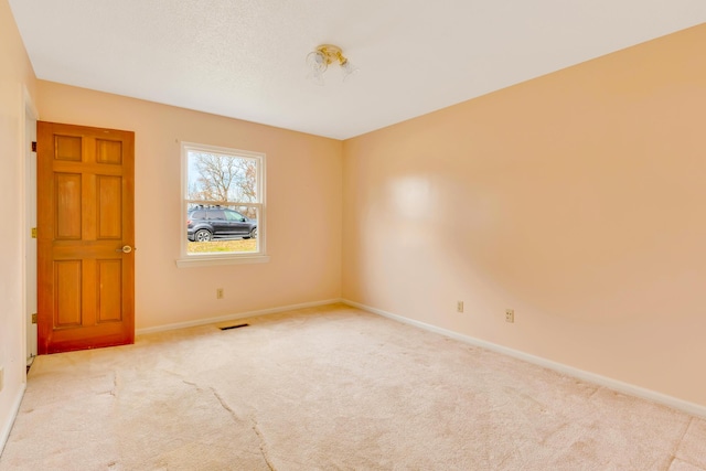 unfurnished room featuring light colored carpet