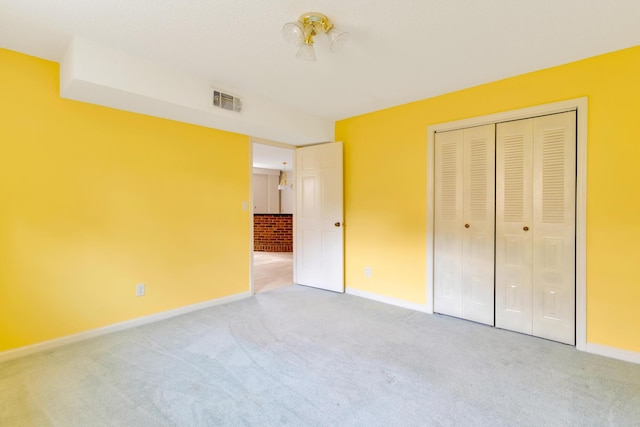 unfurnished bedroom featuring carpet flooring and a closet