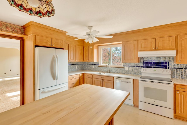 kitchen featuring white appliances, sink, ceiling fan, tasteful backsplash, and butcher block countertops