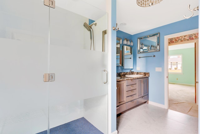 bathroom with vanity and a shower with shower door