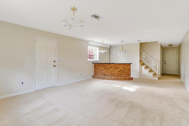 unfurnished living room with a chandelier, light colored carpet, and a fireplace