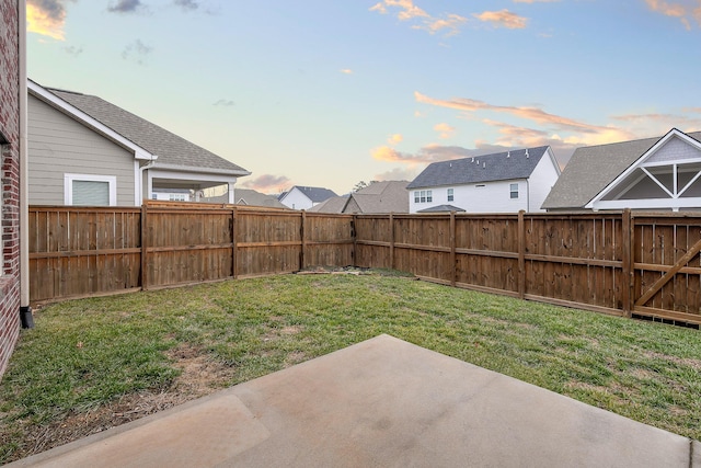 yard at dusk with a patio area