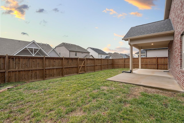 yard at dusk with a patio