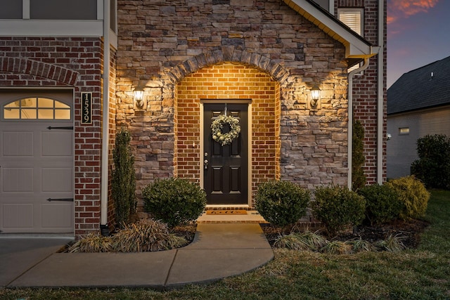 view of exterior entry at dusk