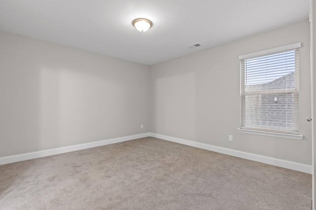 unfurnished room featuring light carpet